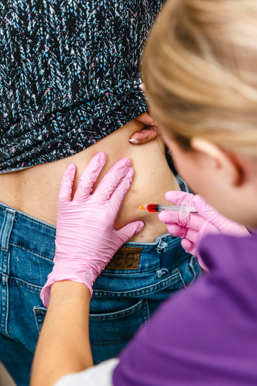 Provider injecting client with medical weightloss treatment