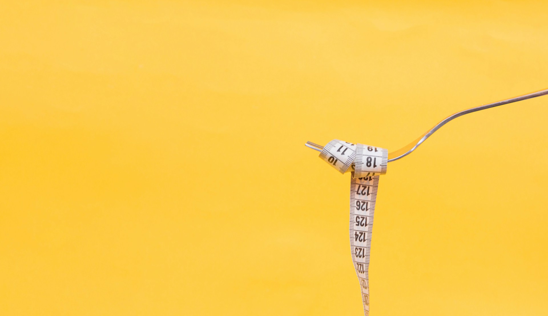 fun image of measuring tape wrapped in a spoon like spaghetti