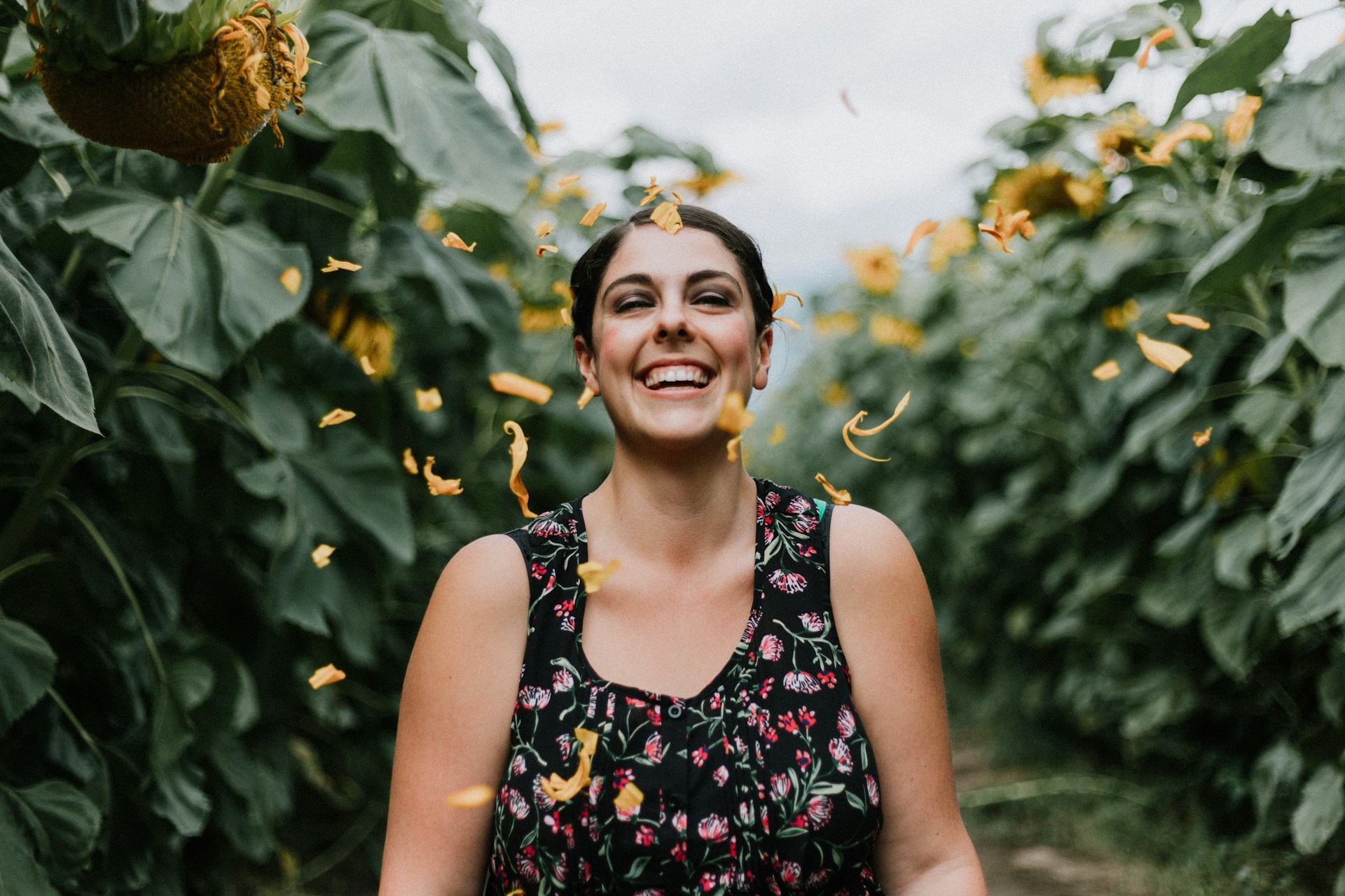 woman smiling standing surrounded by plants